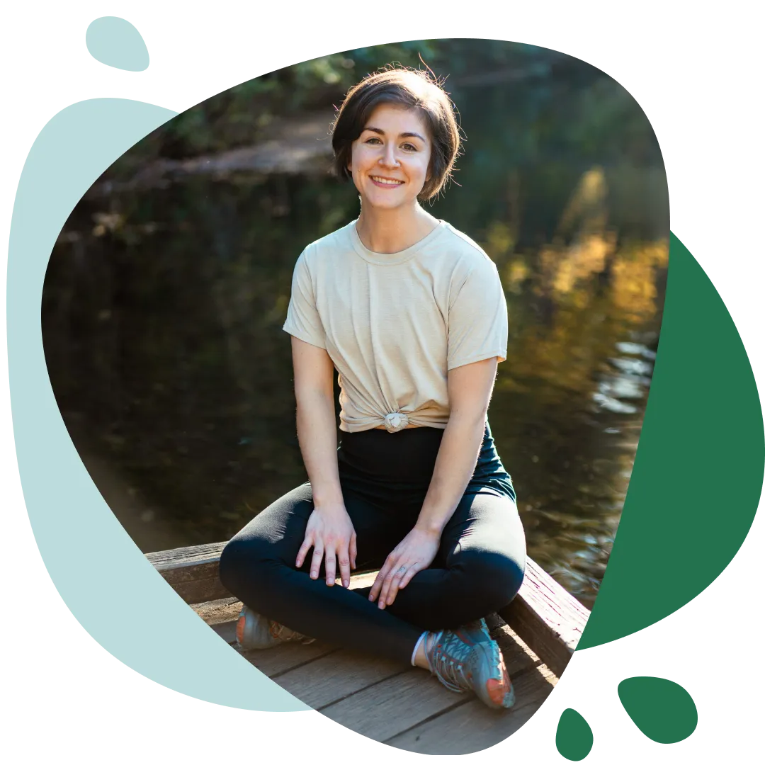 Lexi Brown seated on a pier and smiling